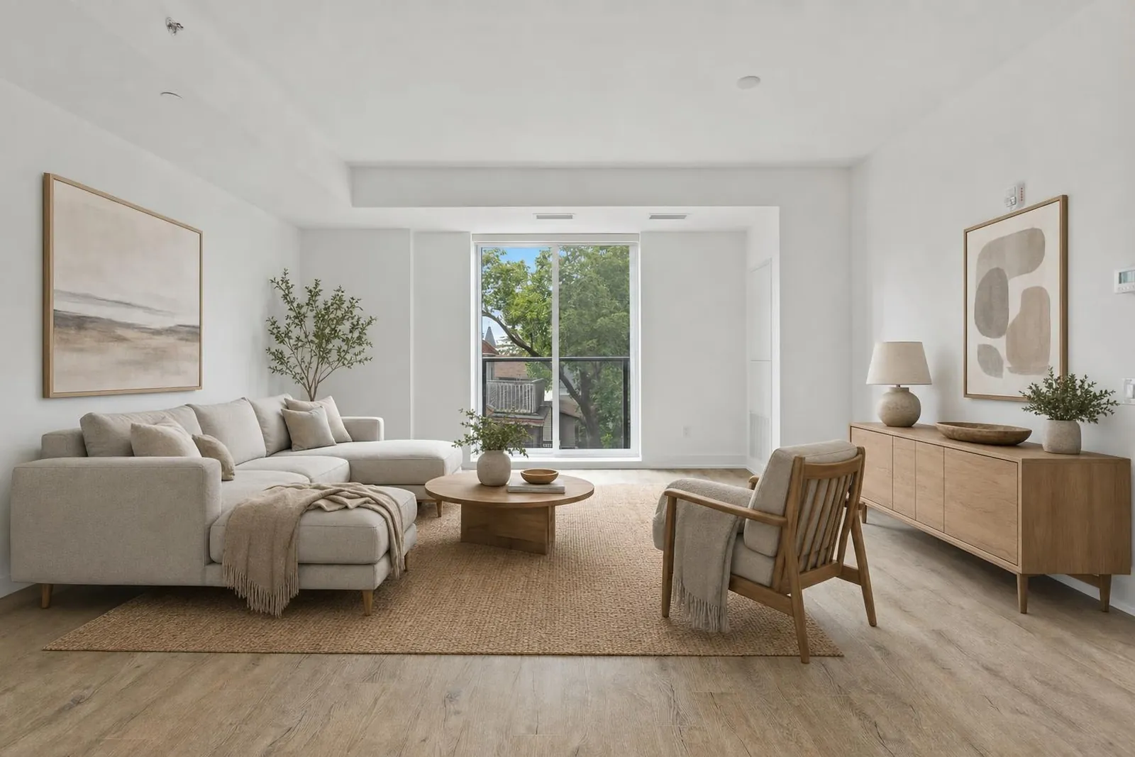 The same living room staged in a Scandinavian style with a sectional sofa, rug and oak sideboard